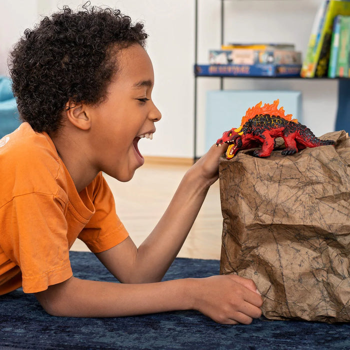 Child playing with Magma Lizard figurine