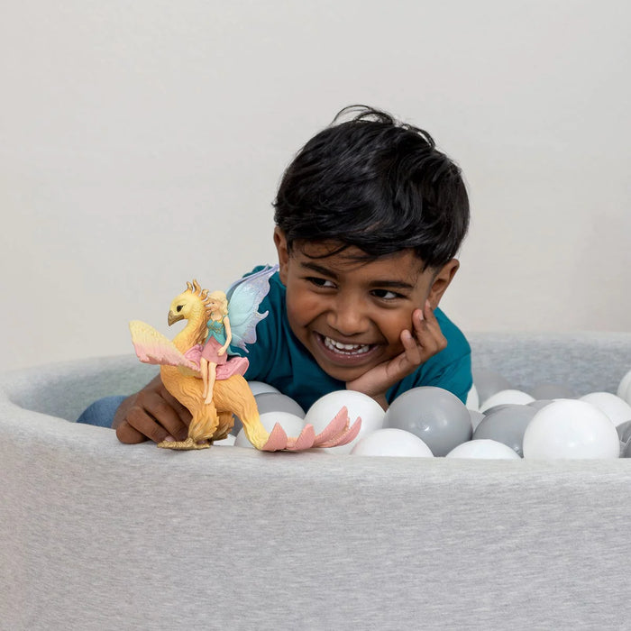 Kid playing with Phoenix bird figurine