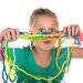 girl holding multicoloured slime strings infront of her face