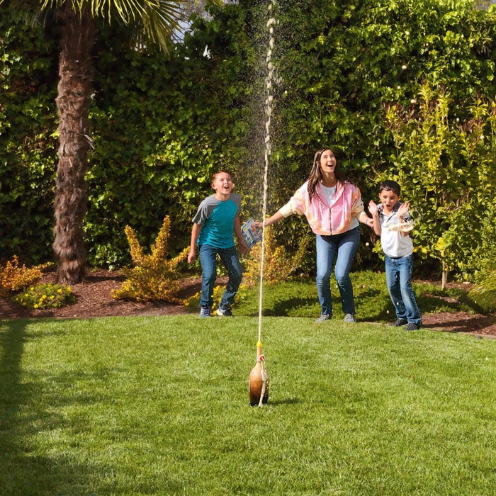 geyser tube science experiment example with mom and kids watching stream of pop in air